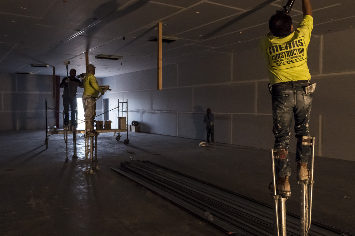 Dry wallers prepping an Adelanto warehouse for large-scale indoor commercial cannabis cultivation. Photo: Kim Stringfellow.