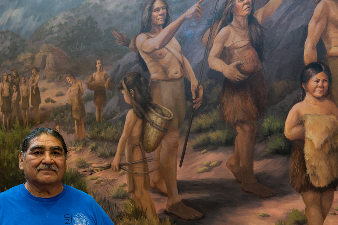 Matt Leivas, Sr. in front of a mural created by Jeanine Hattas Wilson at the Chemehuevi Cultural Center, Havasu Lake, CA. Photo: Kim Stringfellow.